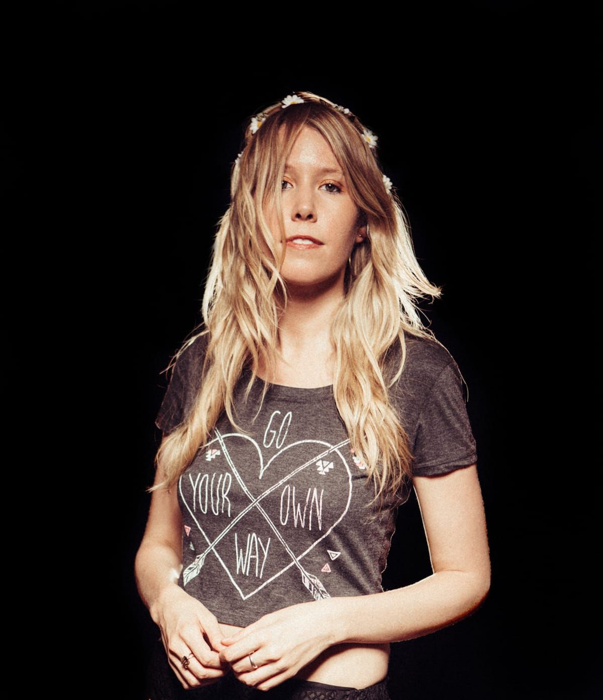 Portrait of a woman with long blond hair in a graphic T-shirt