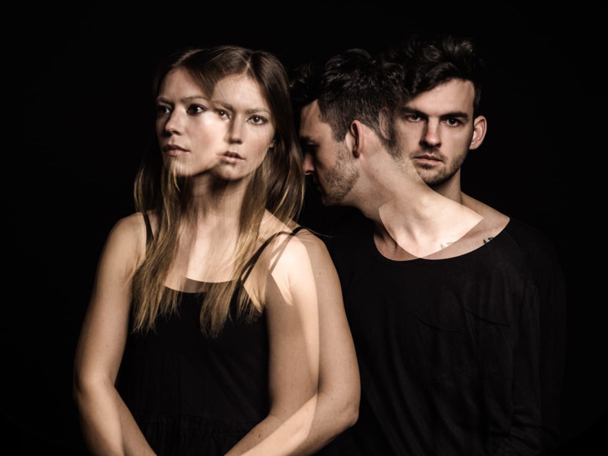Two actors posed together against a dark backdrop
